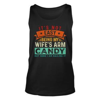 Its Not Easy Being My Wifes Arm Candy But Here I Am Nailin Unisex Tank Top | Mazezy