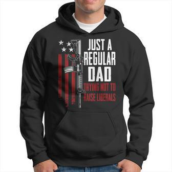 Just A Regular Dad Trying Not To Raise Liberals - On Back Hoodie - Seseable