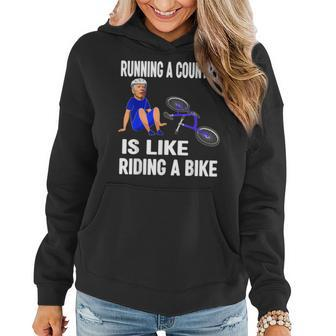 Biden Falls Off Bike Joe Biden Falling Off His Bicycle Funny Women Hoodie Graphic Print Hooded Sweatshirt - Thegiftio