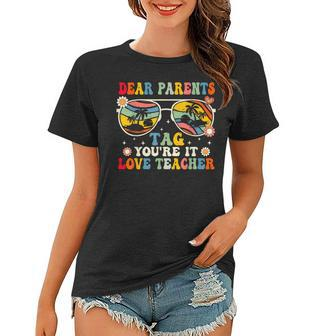Groovy Dear Parents Tag Youre It Last Day Of School Teacher Women T-shirt | Mazezy