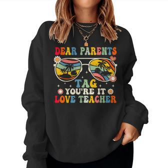 Groovy Dear Parents Tag Youre It Last Day Of School Teacher Women Sweatshirt | Mazezy UK