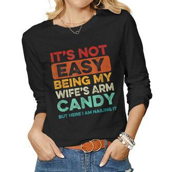 Mens Its Not Easy Being My Wife Arm Candy But Here I Am Nailing Women Long Sleeve T-shirt | Mazezy