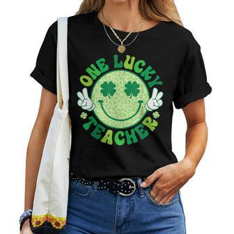 One Lucky Teacher Groovy Smile Face Patrick’S Day Shamrock Women T-shirt | Mazezy