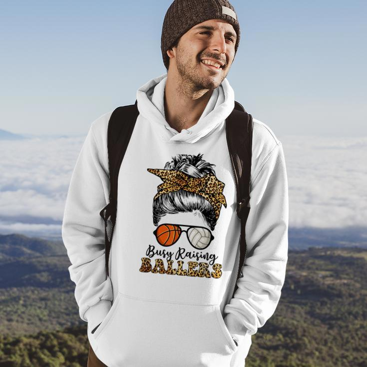 Busy Raising Ballers Basketball And Volleyball Mom Messy Bun Hoodie Lifestyle