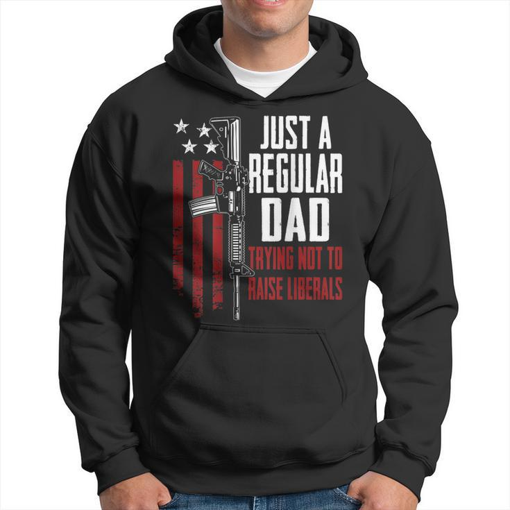 Just A Regular Dad Trying Not To Raise Liberals - On Back  Hoodie