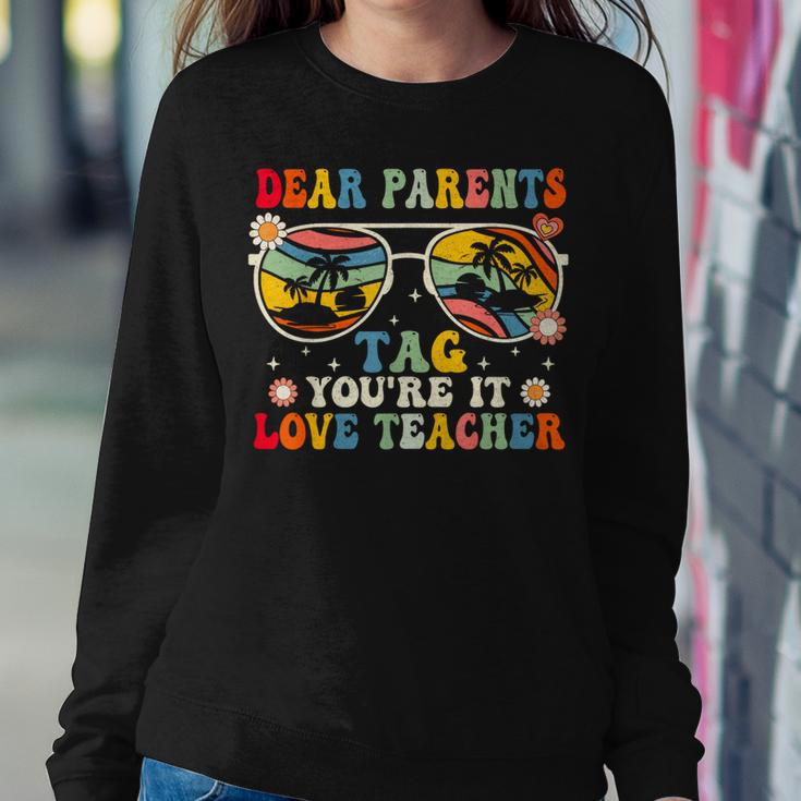 Groovy Dear Parents Tag Youre It Last Day Of School Teacher Women Sweatshirt Unique Gifts