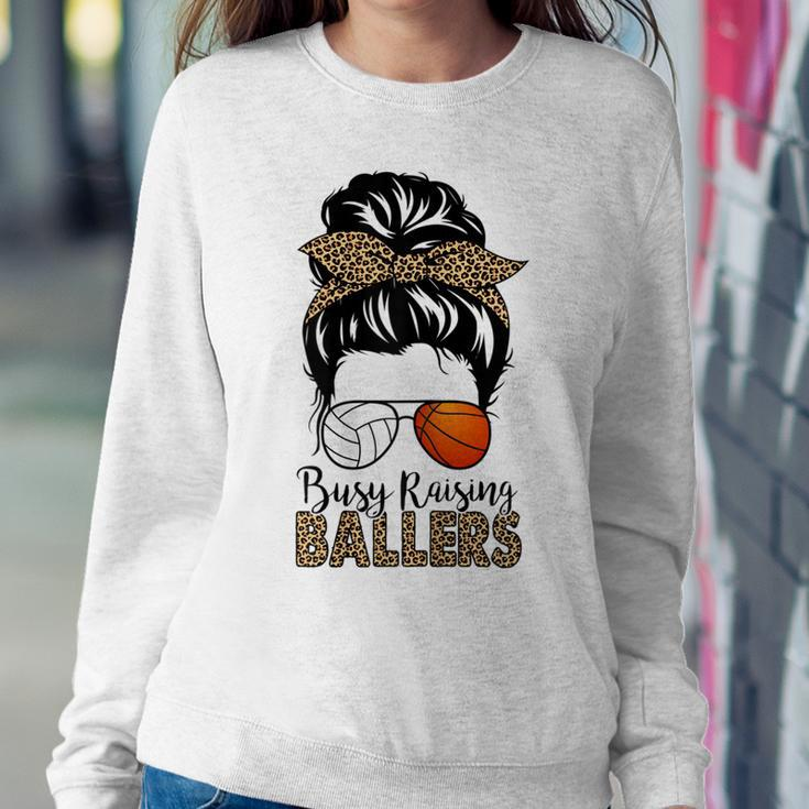 Busy Raising Ballers Basketball And Volleyball Mom Messy Bun Women Sweatshirt Unique Gifts